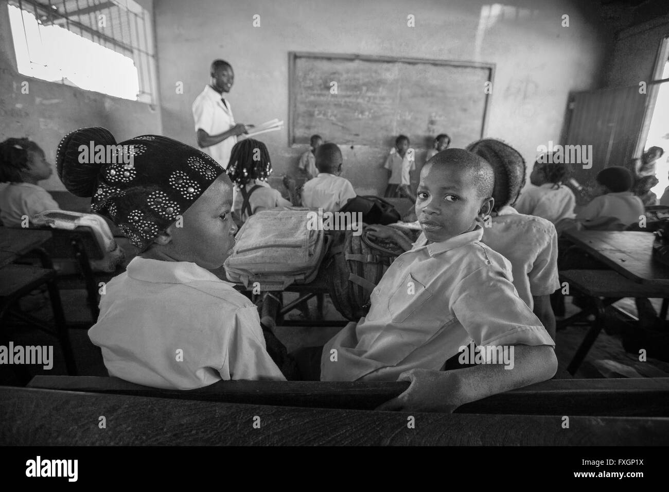 Mozambique,a teacher in a classroom with students is doing a lesson,black and white,B&W. Stock Photo