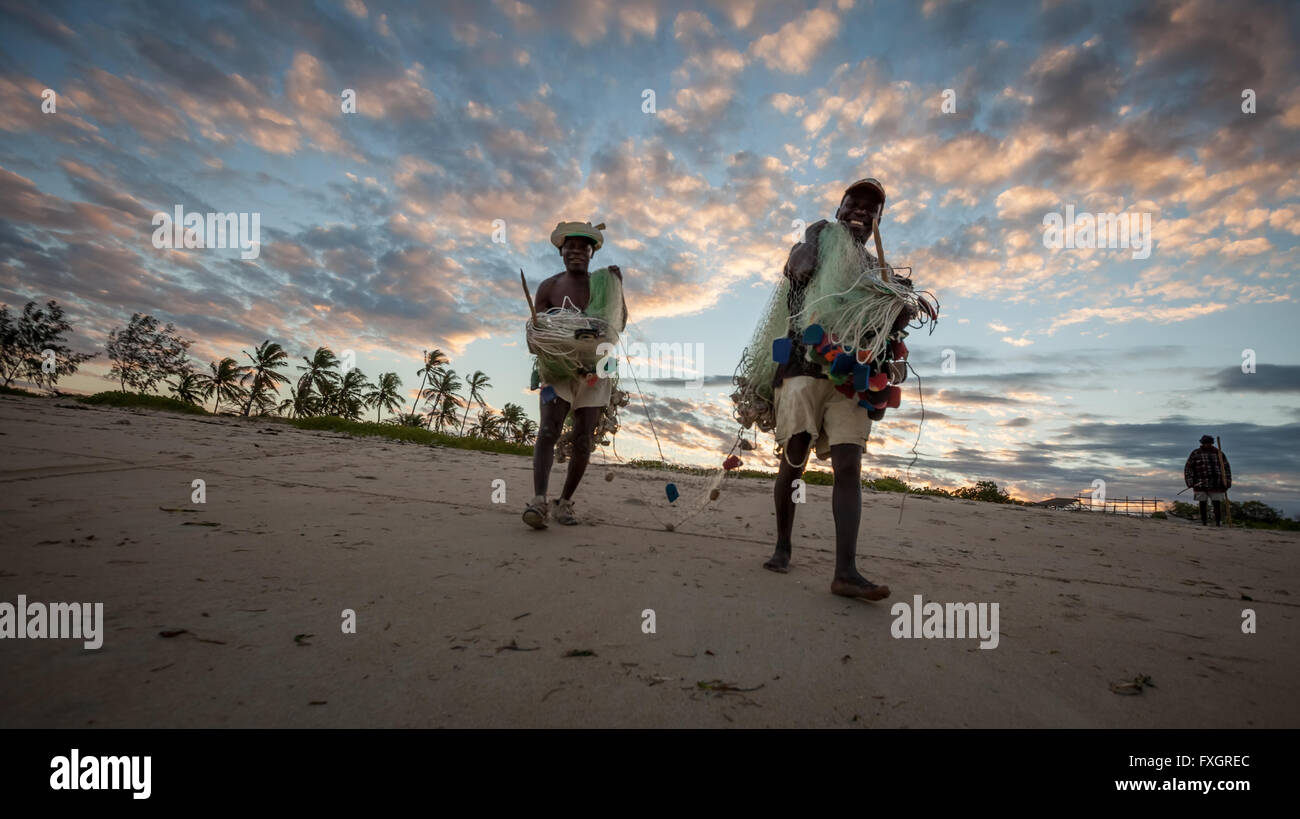 Mozambique, Africa, men on the beach at sunset,back light. Stock Photo