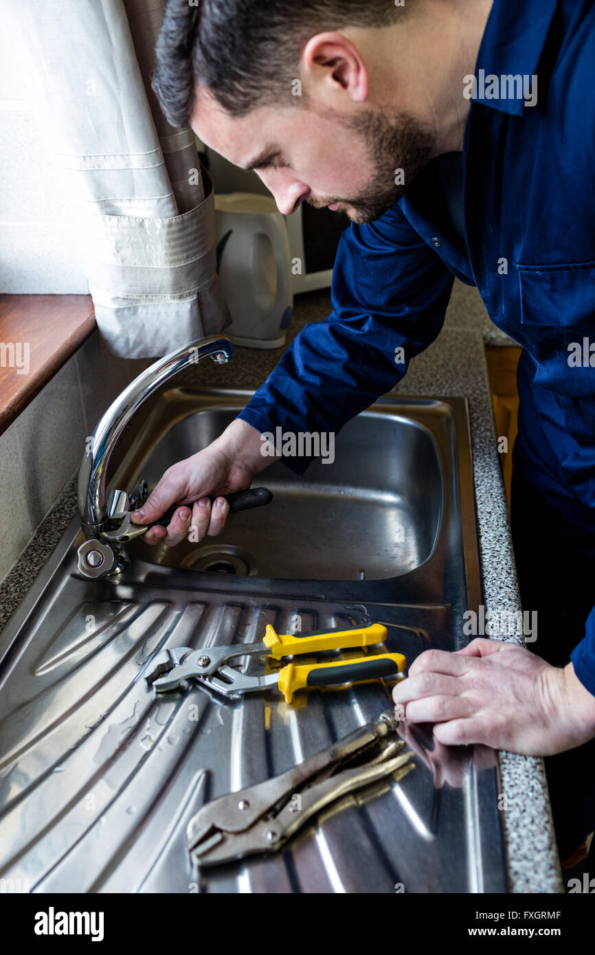 Plumber fixing the sink with wrench Stock Photo Alamy