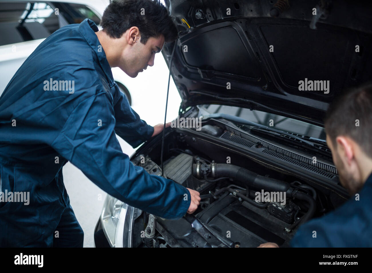 Mechanics Examining Car Engine Stock Photo Alamy Mechanics Examining Car Engine Stock Photo Alamy