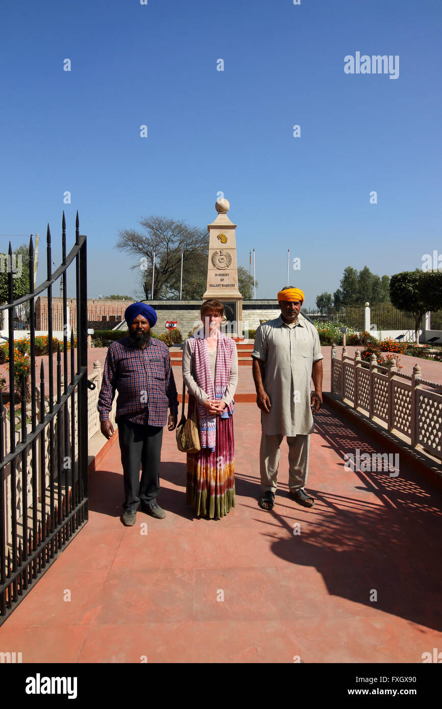 Western lady visitor with local guides at the monument to the Indian heroes of the battle of Pul Kanjari fought in 1971 Stock Photo