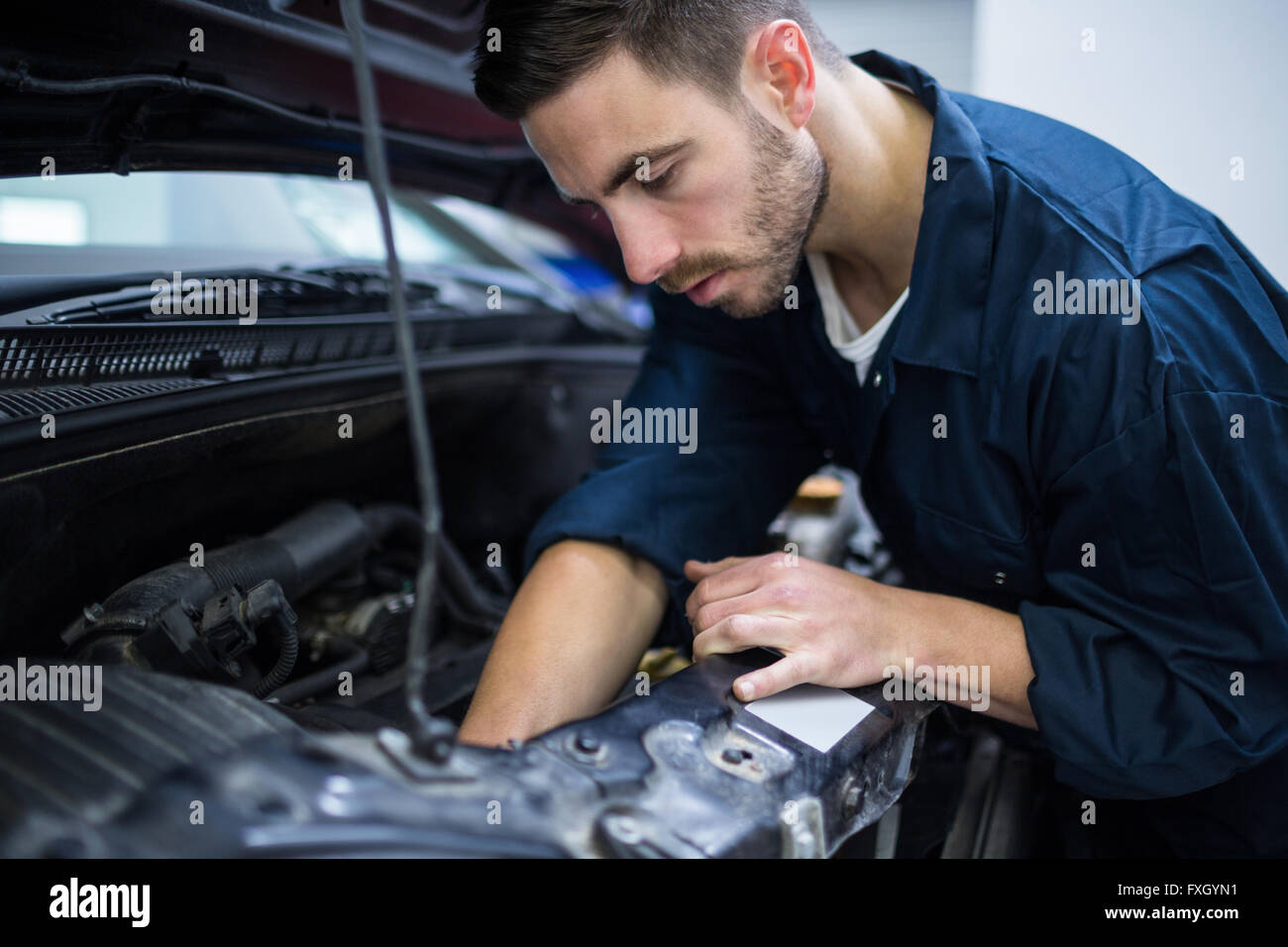 Mechanic examining car engine Stock Photo