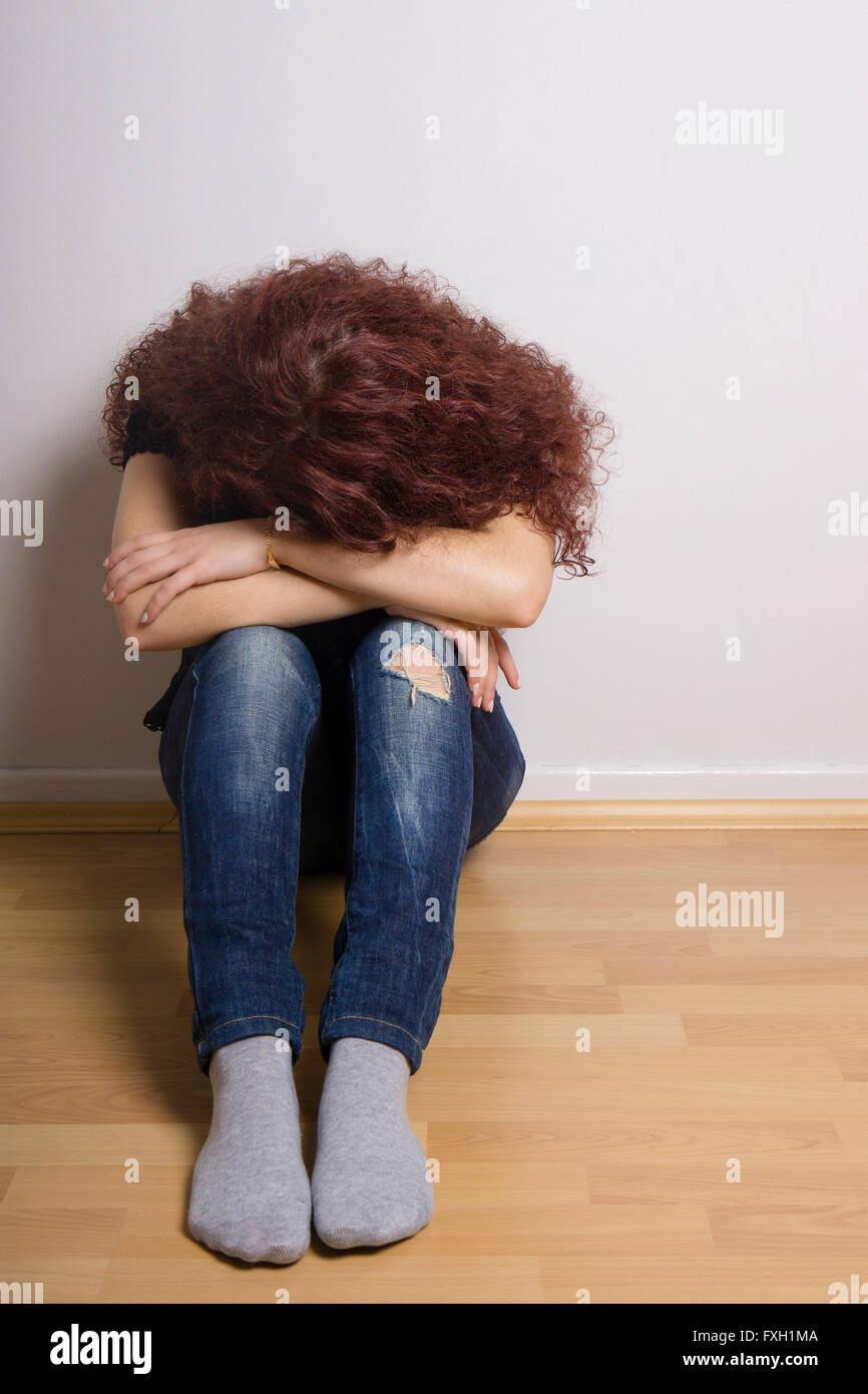 sad depressed young woman hiding her face Stock Photo