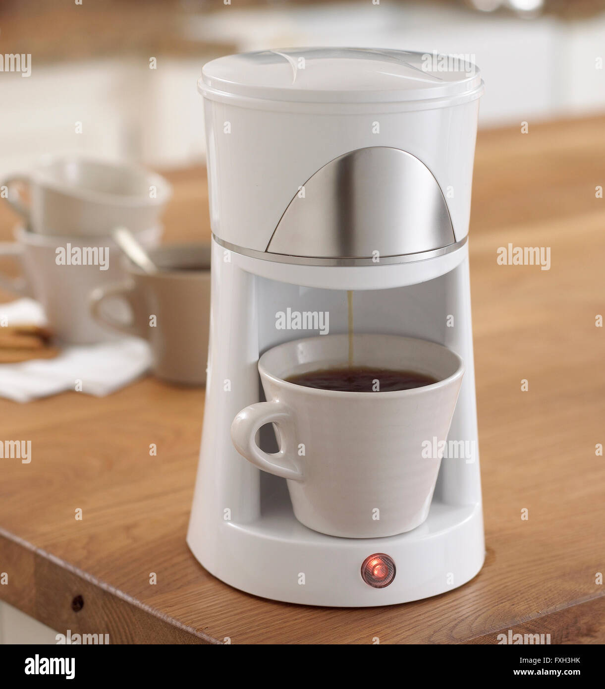 Two espresso cups getting filled in a portafilter machine Stock Photo -  Alamy