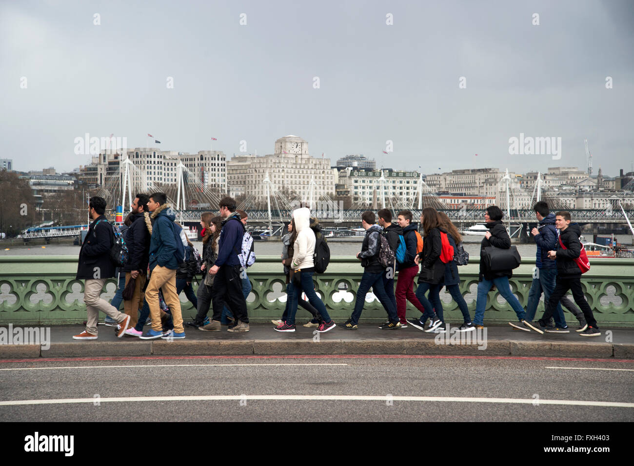 London. School holidays. Students walk across Westminster Bridge . Stock Photo