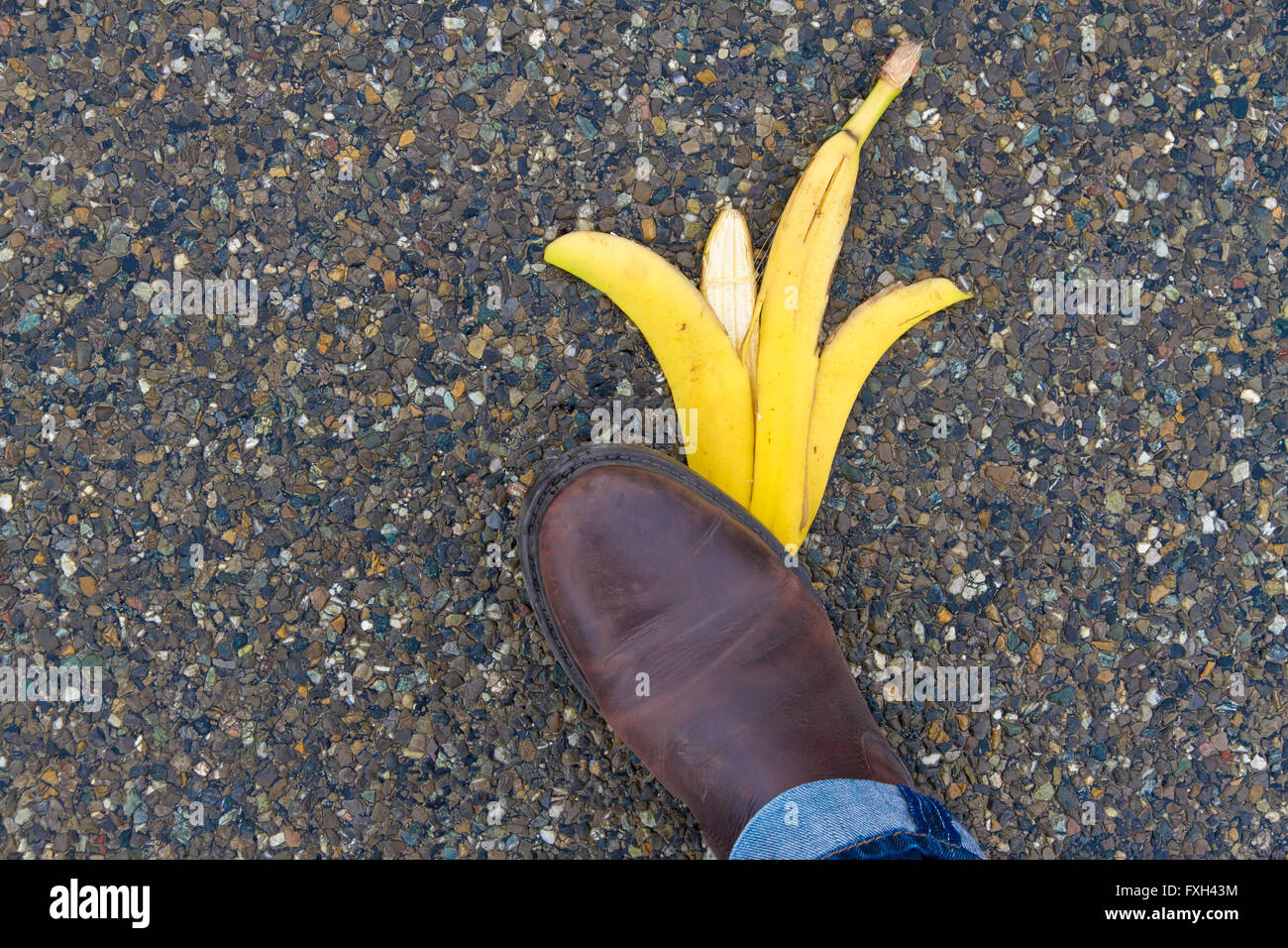 Man about to slip and fall on a banana skin Stock Photo