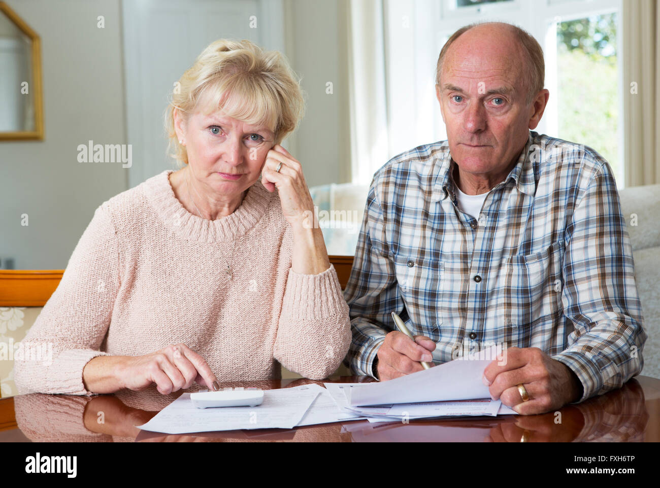 Concerned Senior Couple Reviewing Domestic Finances Stock Photo