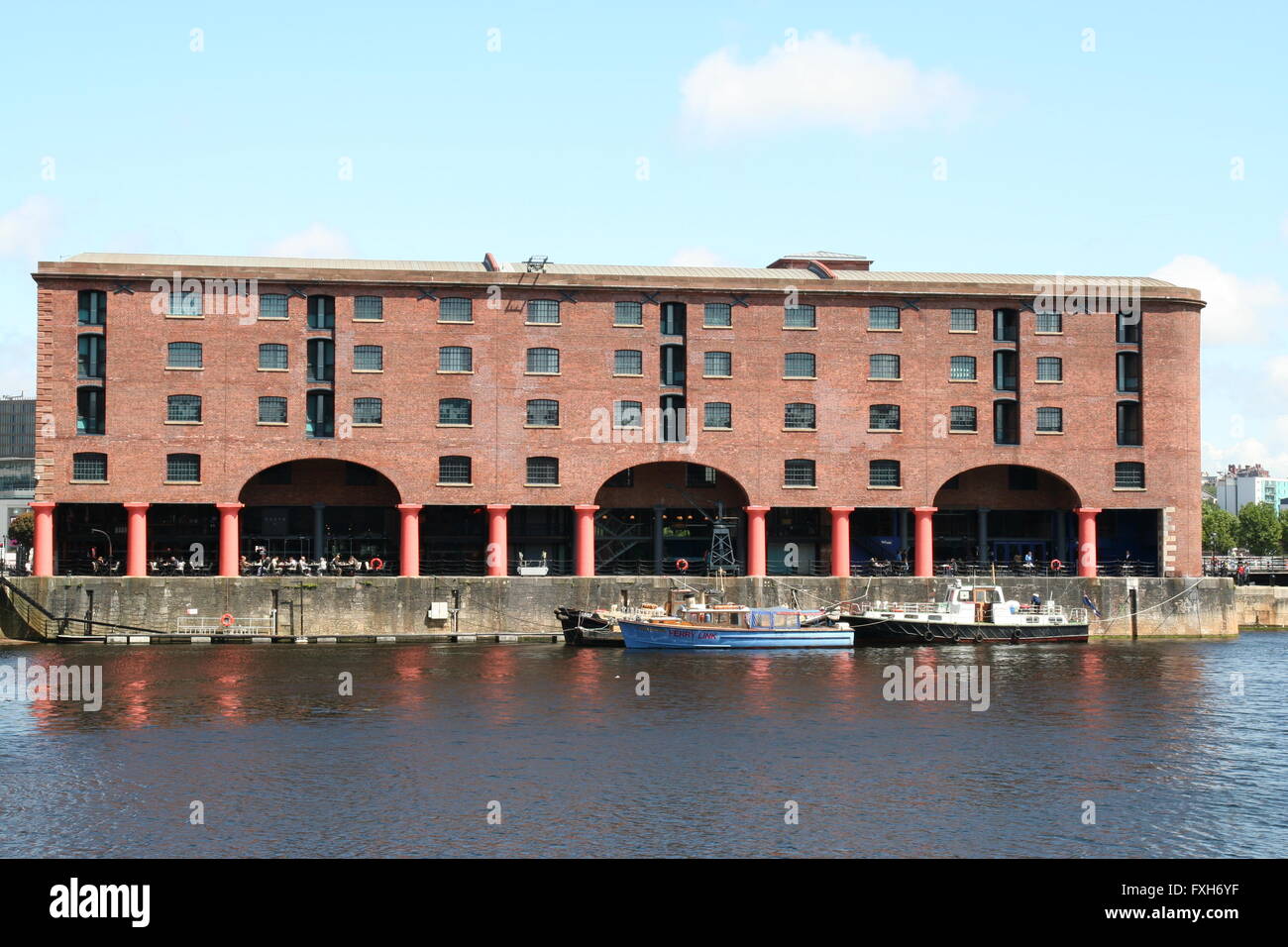 Albert Docks,Liverpool, redeveloped as a tourist attraction. Older boats are tied at the quayside. Stock Photo