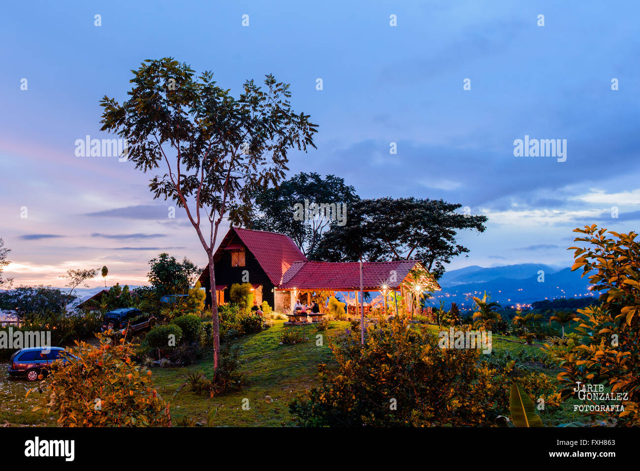 Sun setting in front of a hut in Santa Elena, Perez Zeledon, Costa Rica Stock Photo