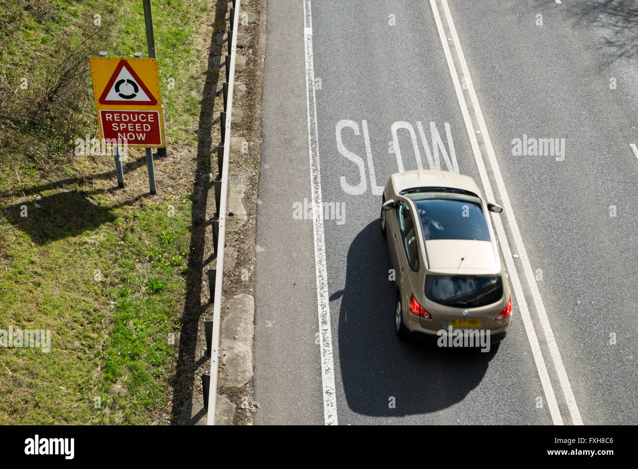 Car braking at warning to slow down on UK road Stock Photo