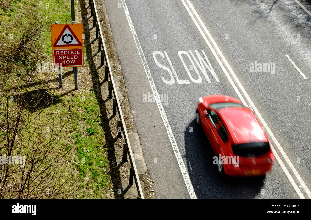 Speeding car approaching warning to slow down, on UK road Stock Photo