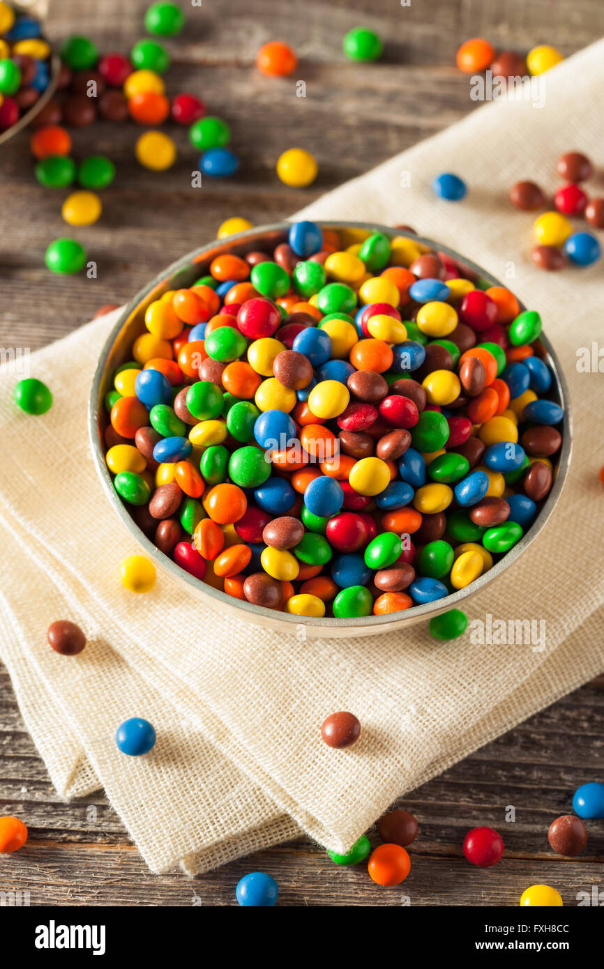 Rainbow Colorful Candy Coated Chocolate Pieces in a Bowl Stock Photo