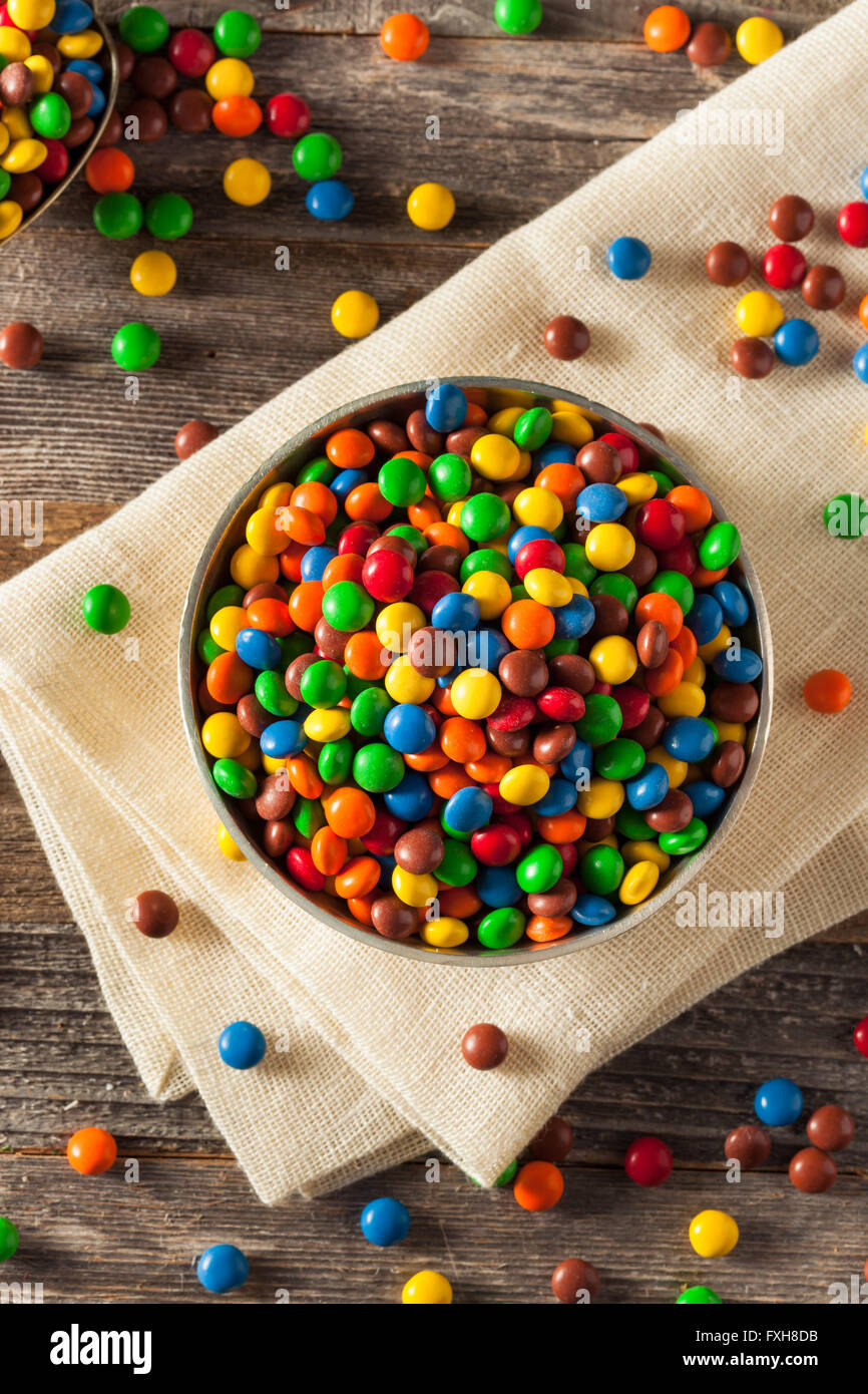 Rainbow Colorful Candy Coated Chocolate Pieces in a Bowl Stock Photo