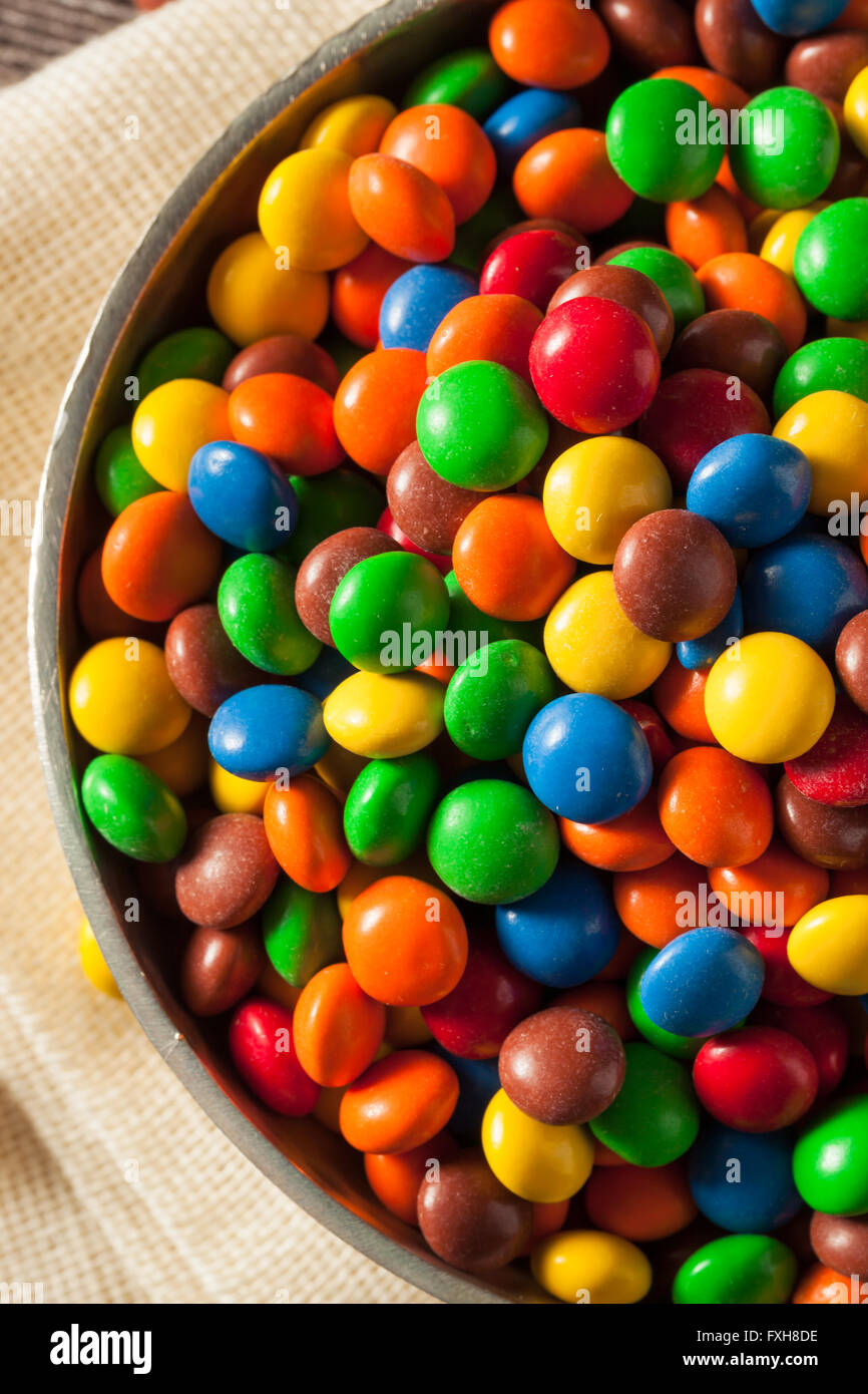 Rainbow Colorful Candy Coated Chocolate Pieces in a Bowl Stock Photo