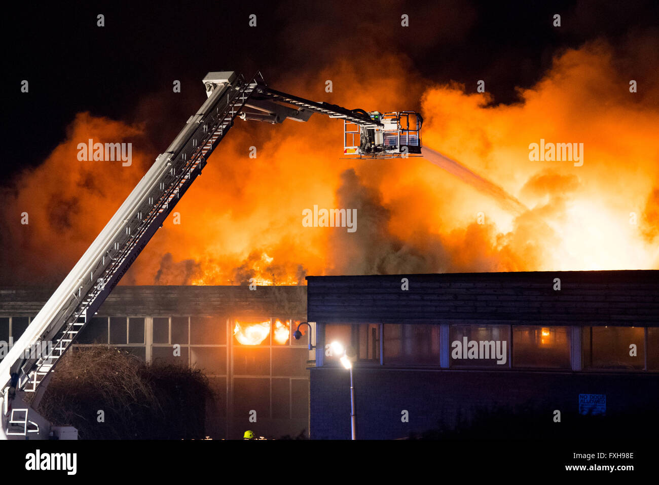 Firefighters tackle a raging burning fire at Glyn Derw High School in Cardiff. Firefighters claimed the fire was arson. Stock Photo