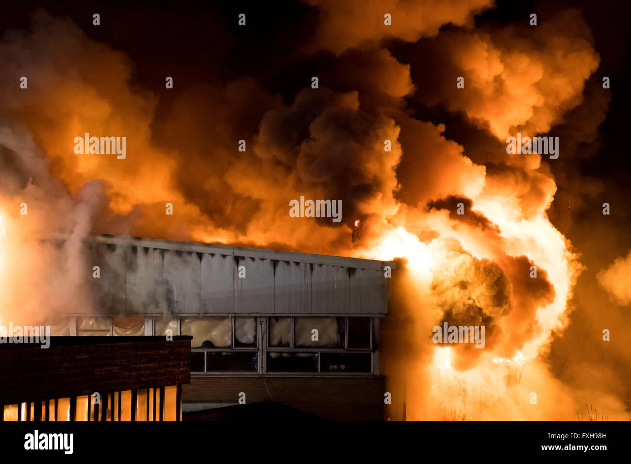 Firefighters tackle a raging burning fire at Glyn Derw High School in Cardiff. Firefighters claimed the fire was arson. Stock Photo