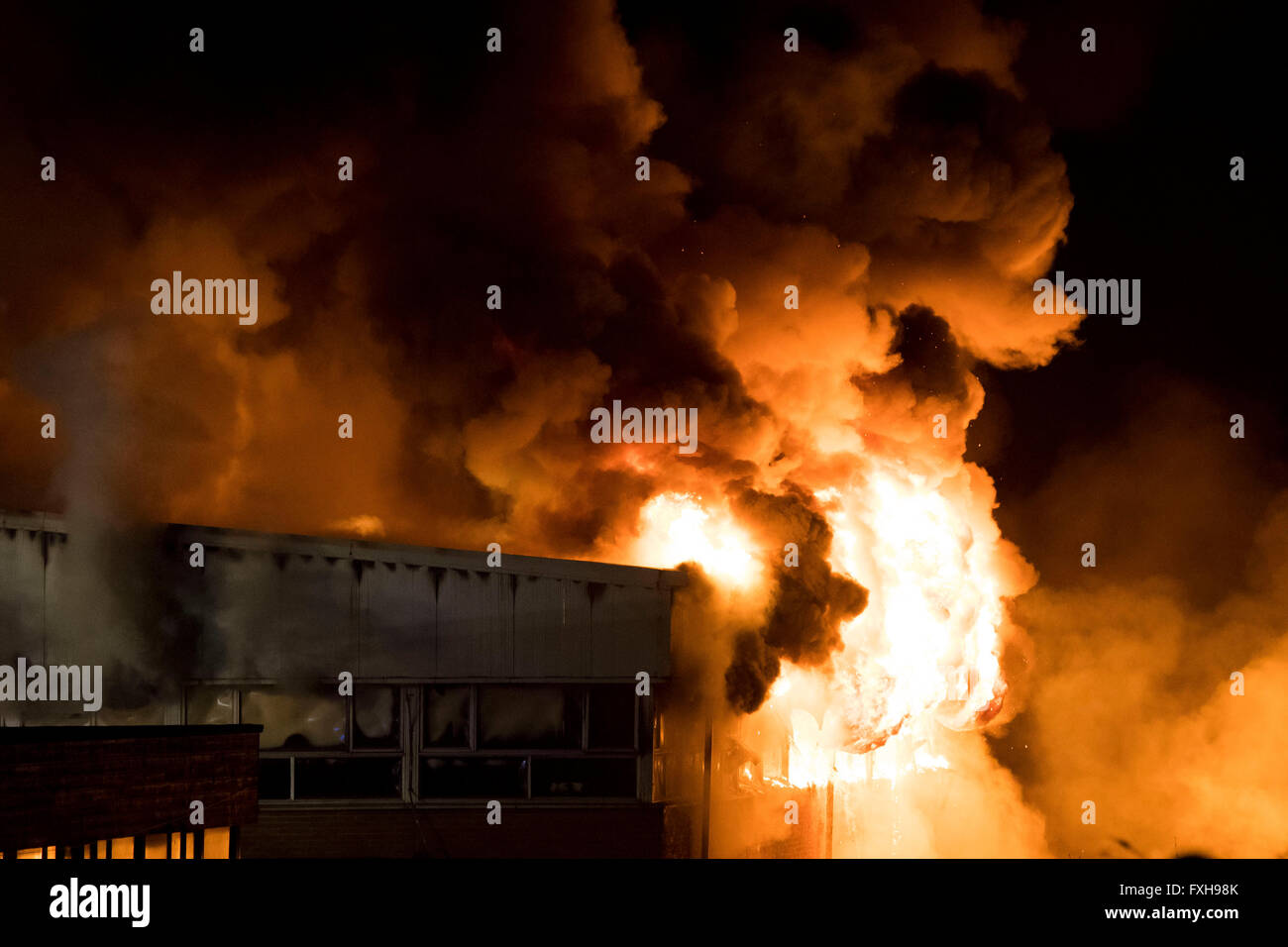 Firefighters tackle a raging burning fire at Glyn Derw High School in Cardiff. Firefighters claimed the fire was arson. Stock Photo