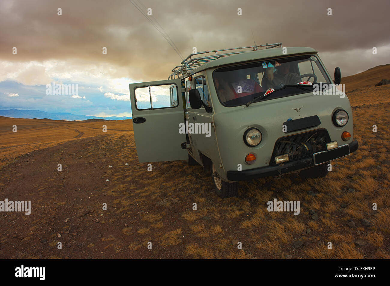 Ubiquitous Russian van on a remote road in Bayan-Olgii. Stock Photo