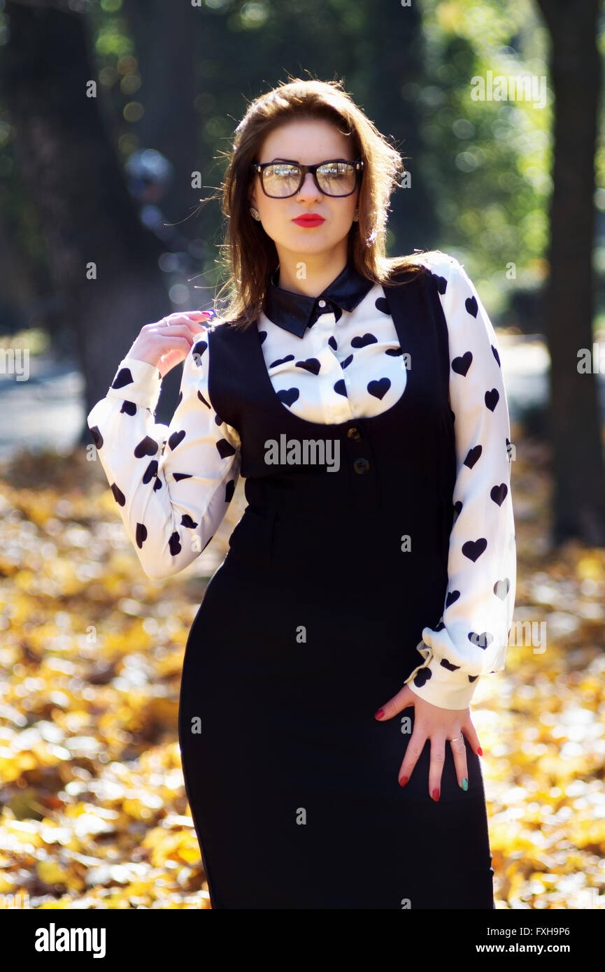 Woman standing in park while looking at camera Stock Photo - Alamy