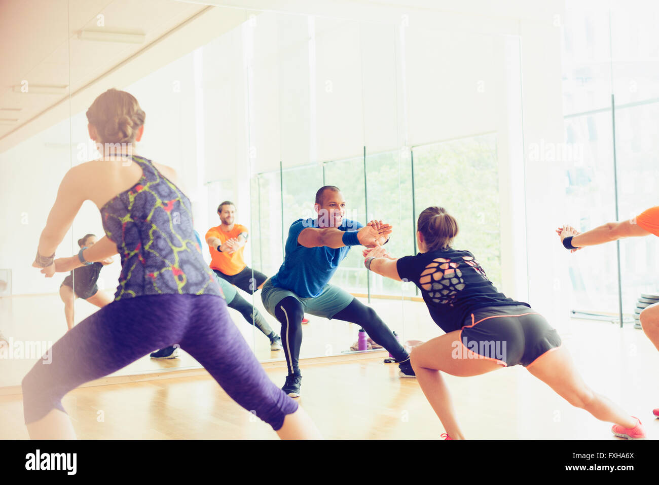 Fitness instructor leading exercise class Stock Photo