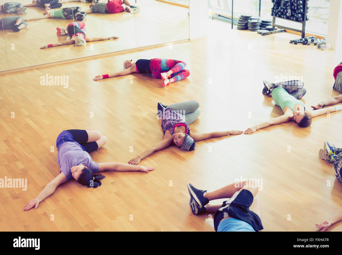 Exercise class doing twisted stretch in studio Stock Photo
