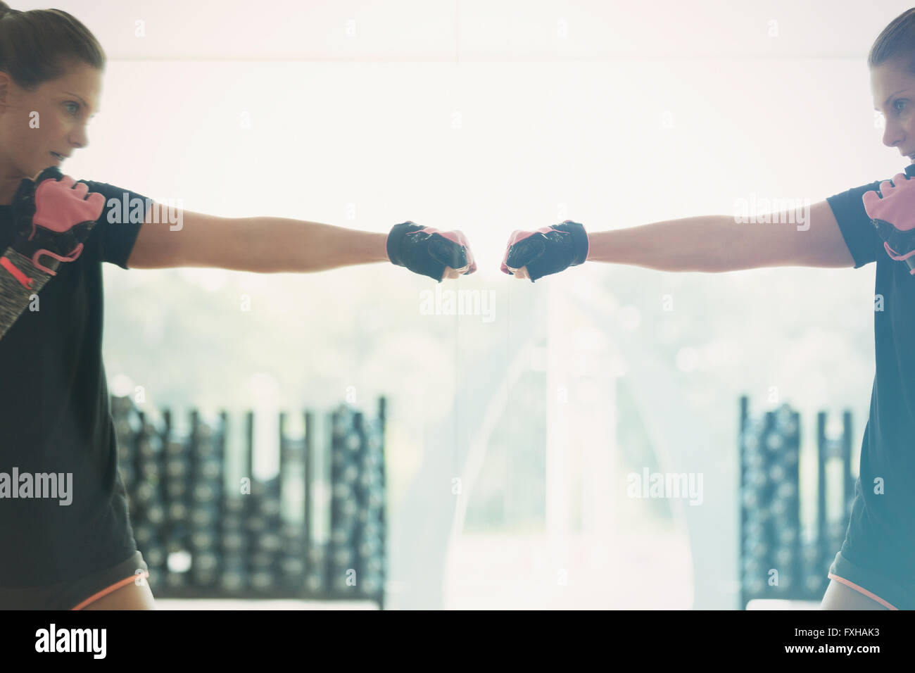 Reflection of woman shadow boxing at gym studio mirror Stock Photo