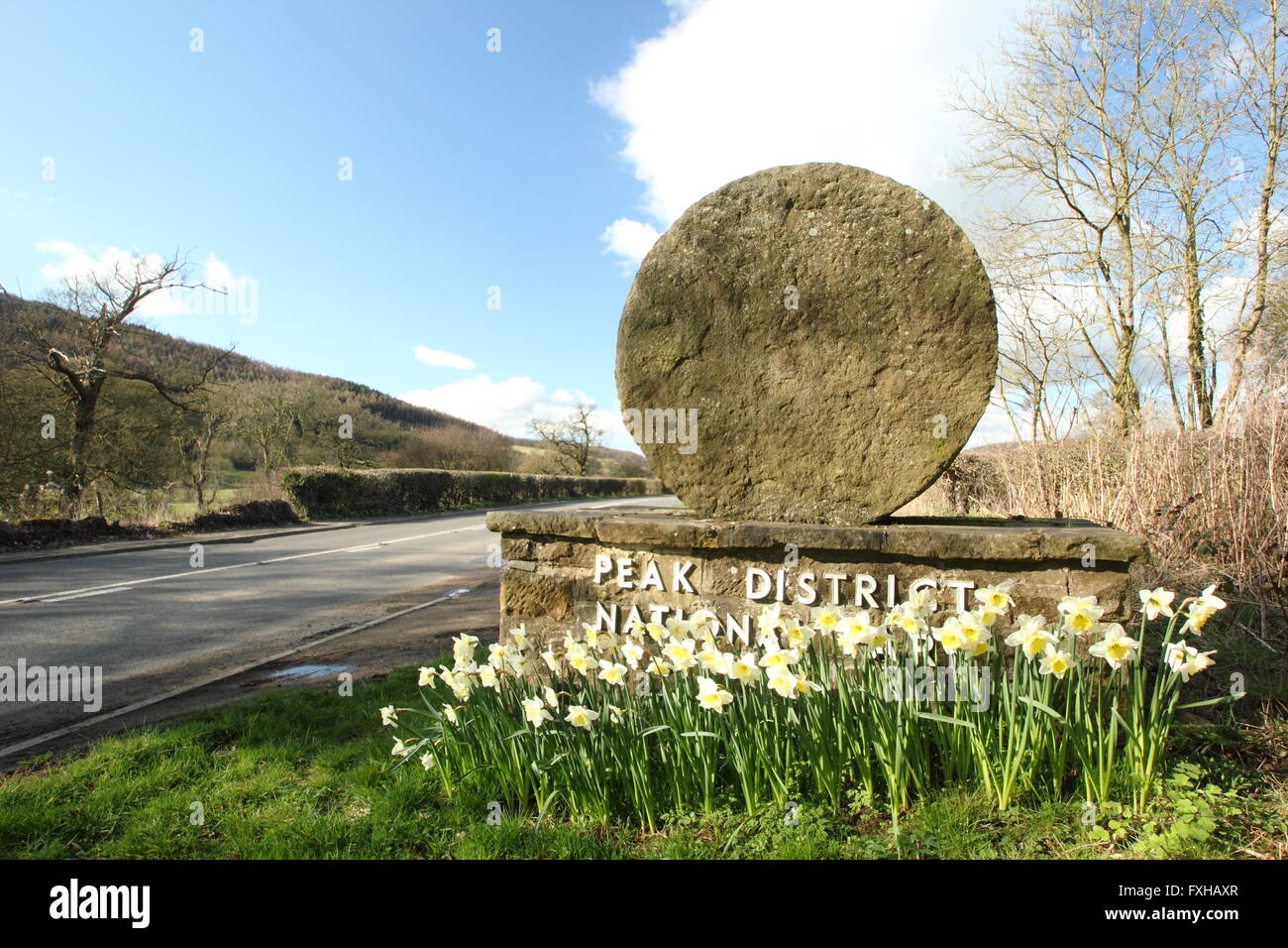 A millstone boundary marker in the Dark Peak region of Peak District National Park, Derbyshire England UK - spring Stock Photo