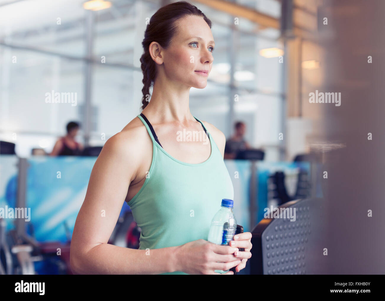 https://c8.alamy.com/comp/FXHB0Y/pensive-woman-drinking-water-at-gym-FXHB0Y.jpg