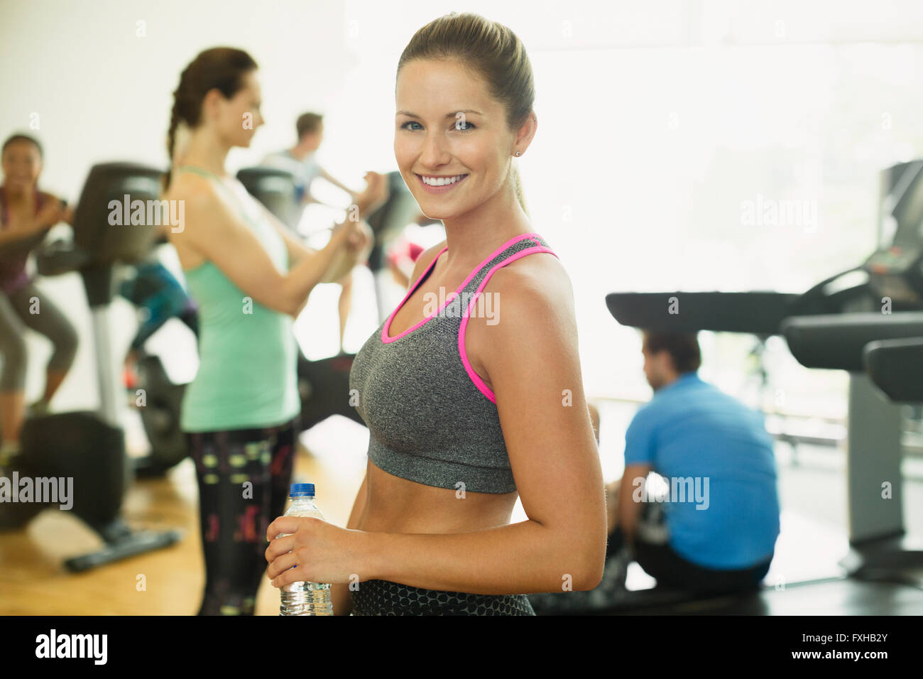 Portrait smiling woman resting at gym Stock Photo