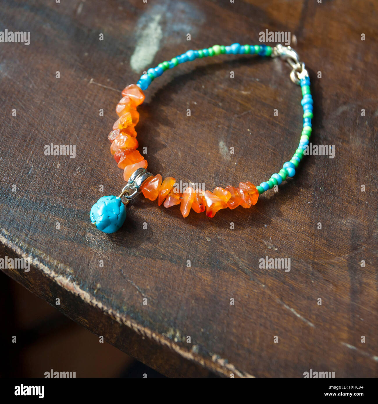 mineral stone yoga bracelet on wooden table Stock Photo