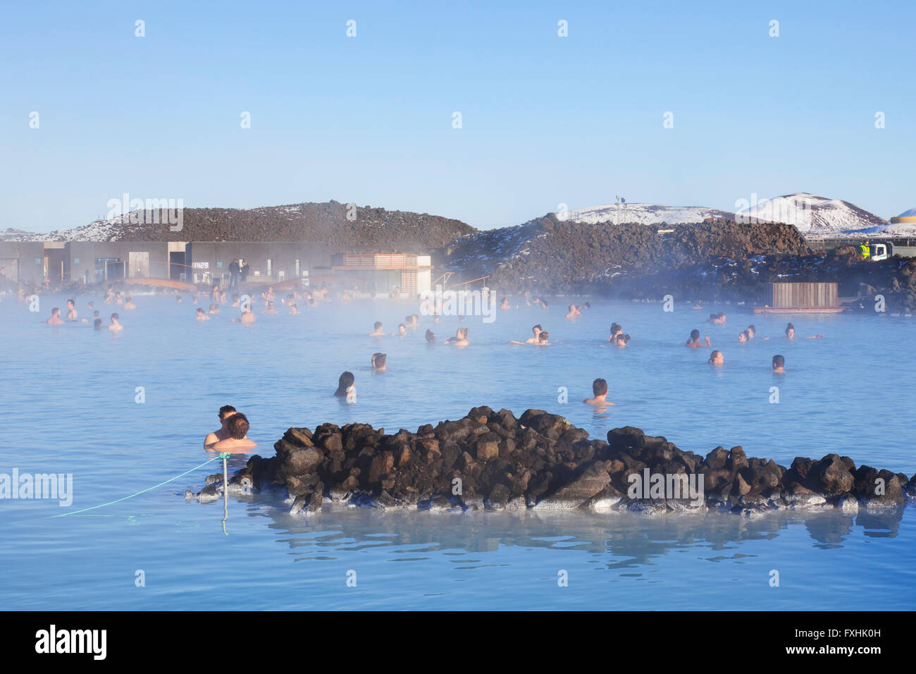 Tourists bathing in Blue Lagoon, rich in minerals like silica and sulfur in winter, Grindavík, Reykjanes Peninsula, Iceland Stock Photo