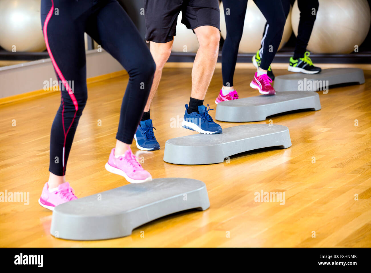 People training with step platform at fitness gym center Stock Photo