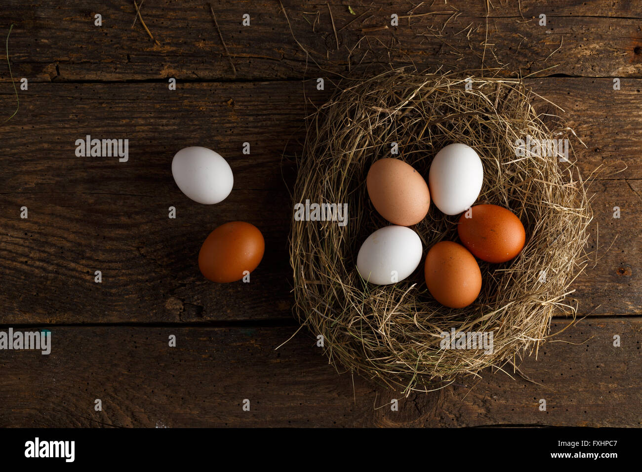 Fresh chicken eggs in a nest on a wooden rustic background Stock Photo ...