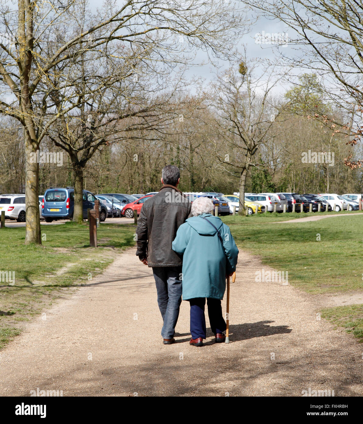 Man out walking with his retired mother. Back view. Stock Photo