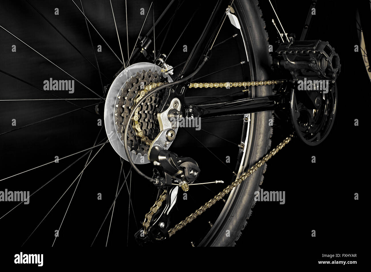Close up of the gears on the rear wheel of a bicycle isolated on black ...