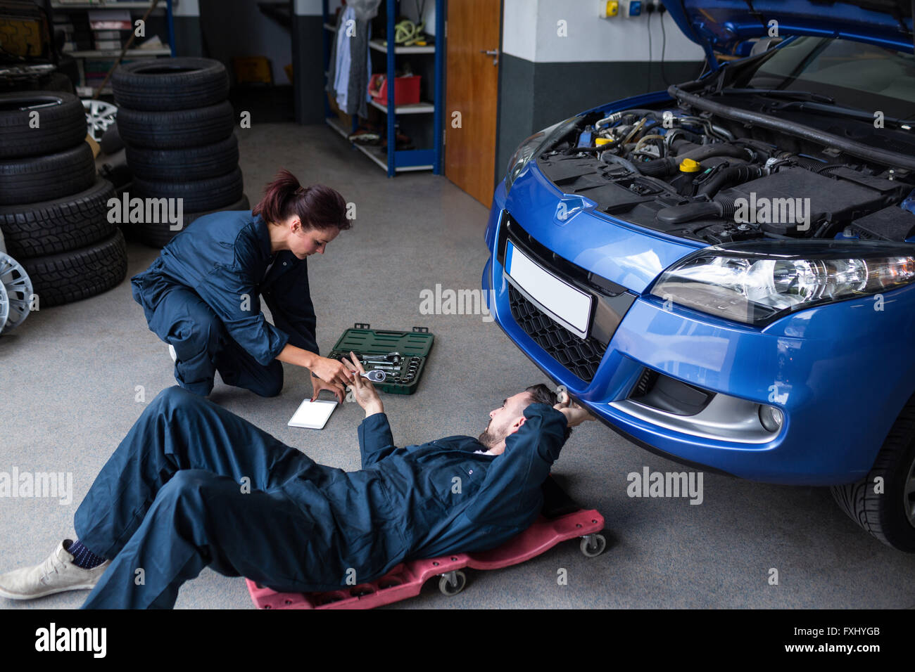 Mechanics Repairing A Car Stock Photo - Alamy