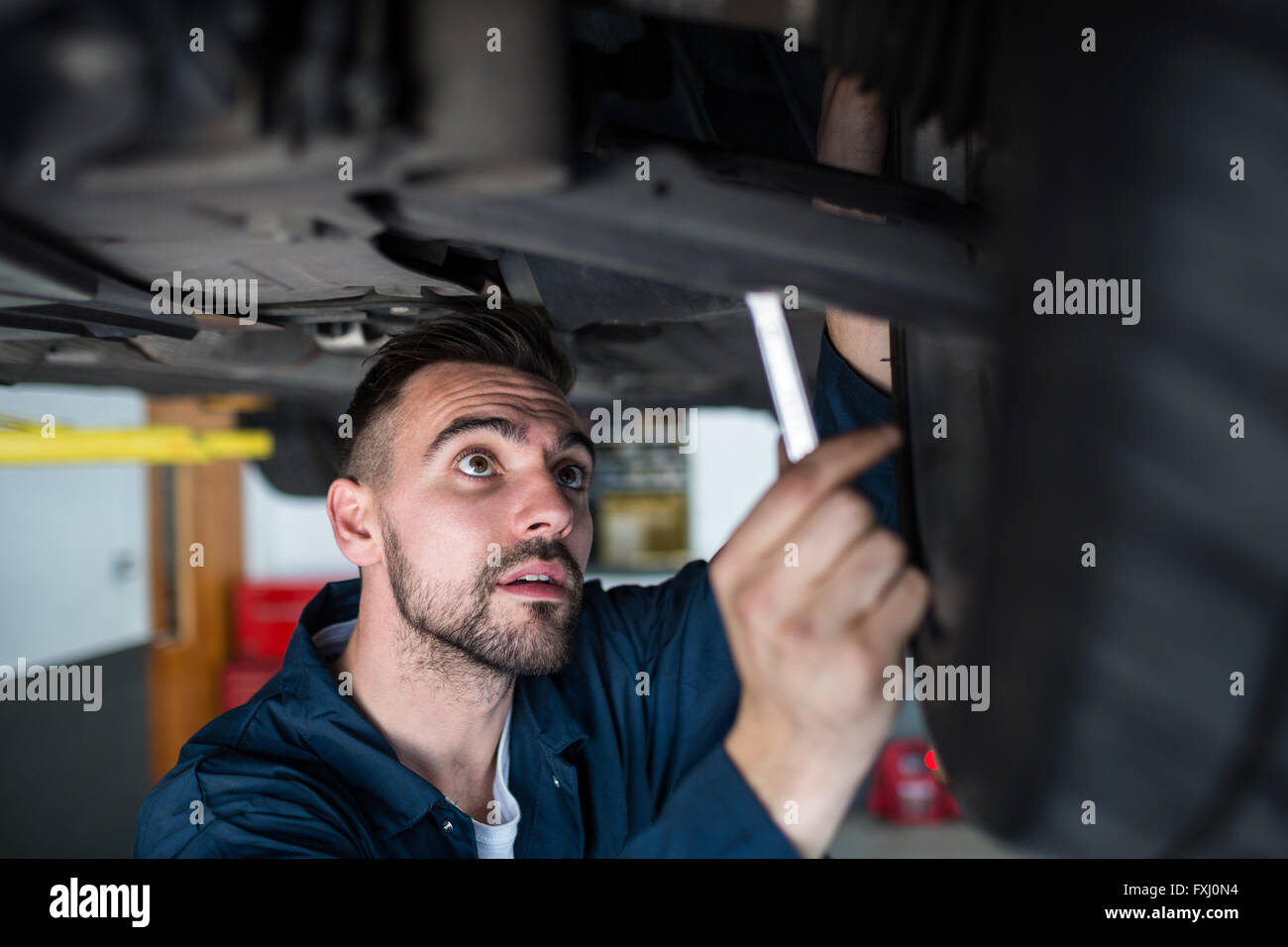 Mechanic examining car tyre Stock Photo