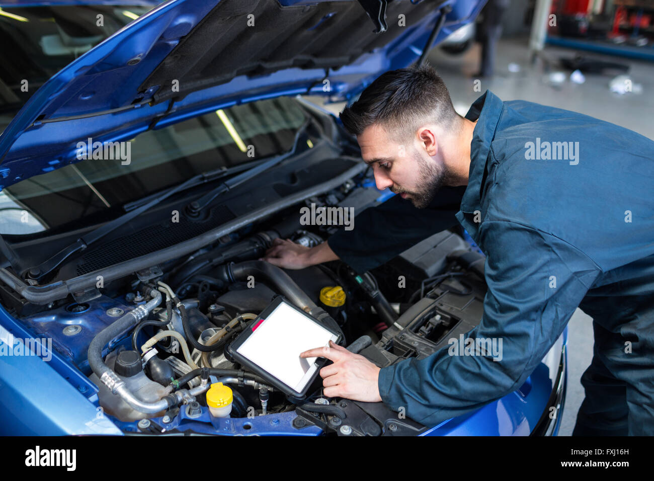Mechanic using a diagnostic tool Stock Photo Alamy
