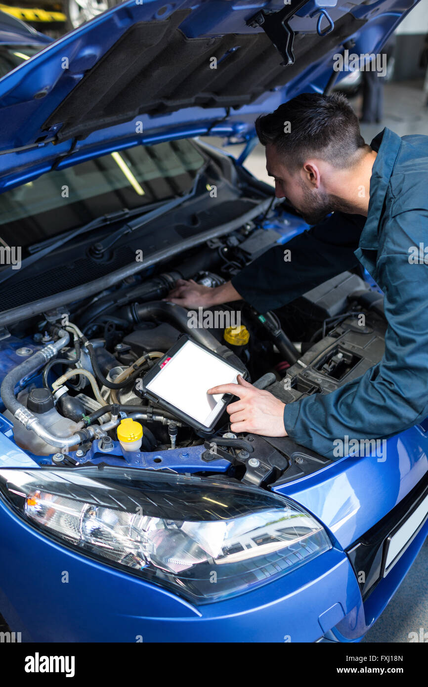 Mechanic using a diagnostic tool Stock Photo Alamy