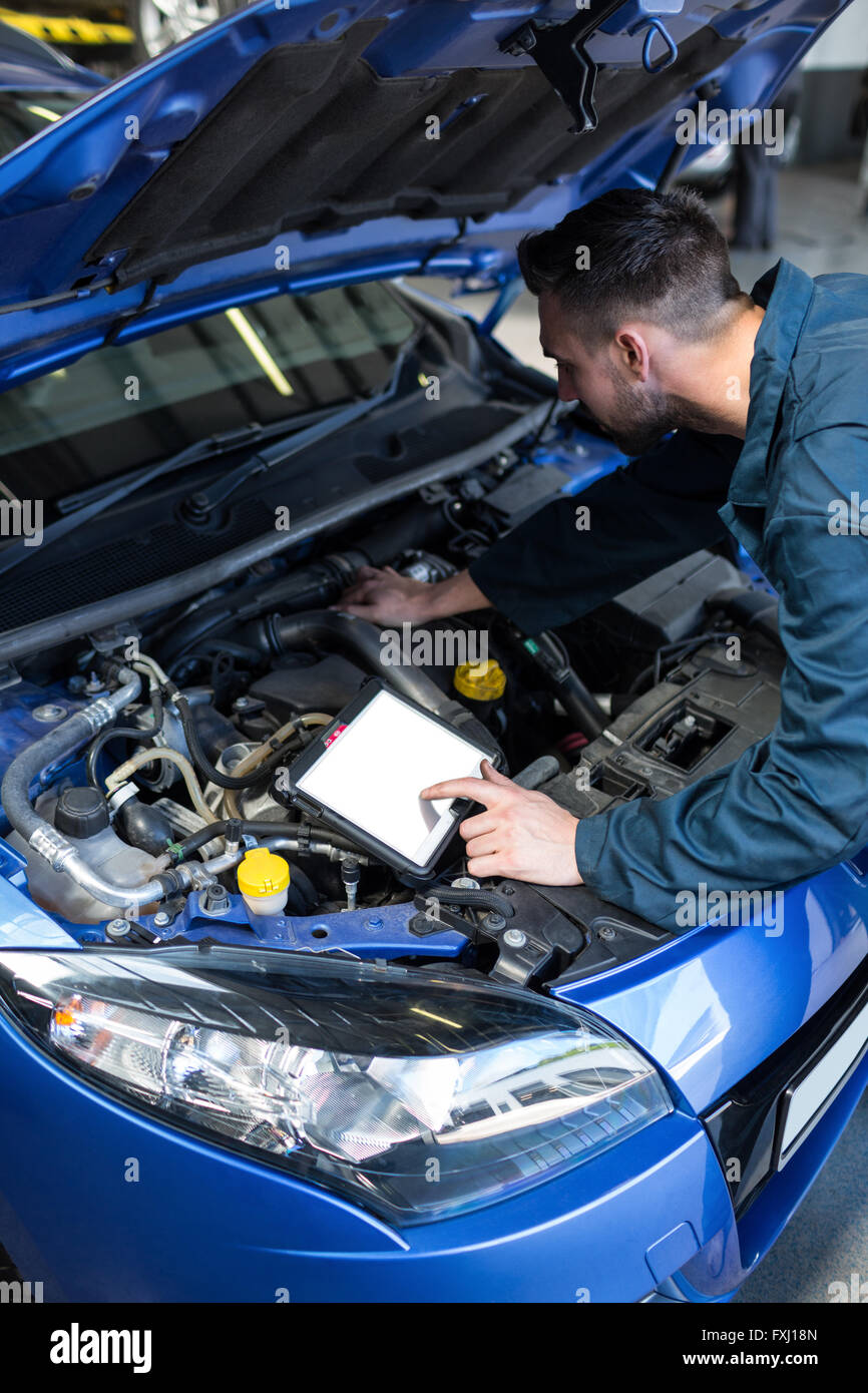 Mechanic using a diagnostic tool Stock Photo