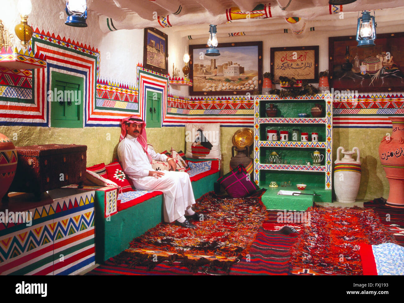 Arab man seated in interior of traditional Saudi home near Abha; Kingdom of Saudi Arabia Stock Photo