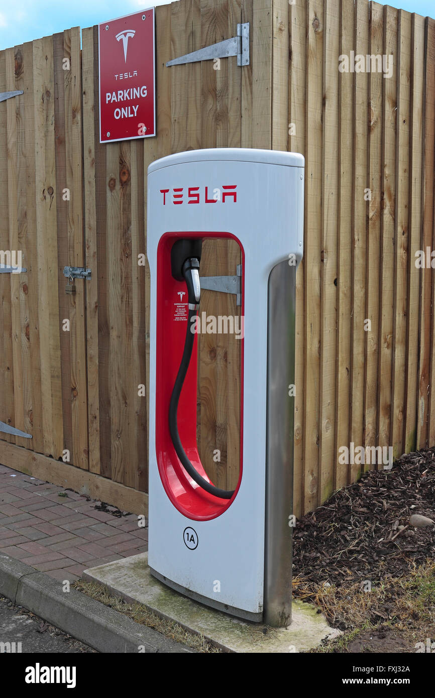 Tesla car charging point at Gretna motorway services in a parking bay