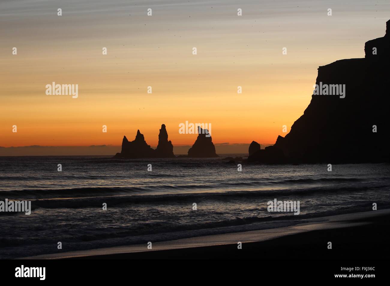 Stone formations at sunset off the southern coast of Iceland Stock Photo