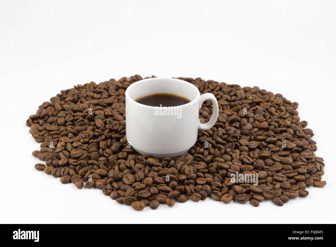 mug of coffee on a background coffee beans scattered Stock Photo