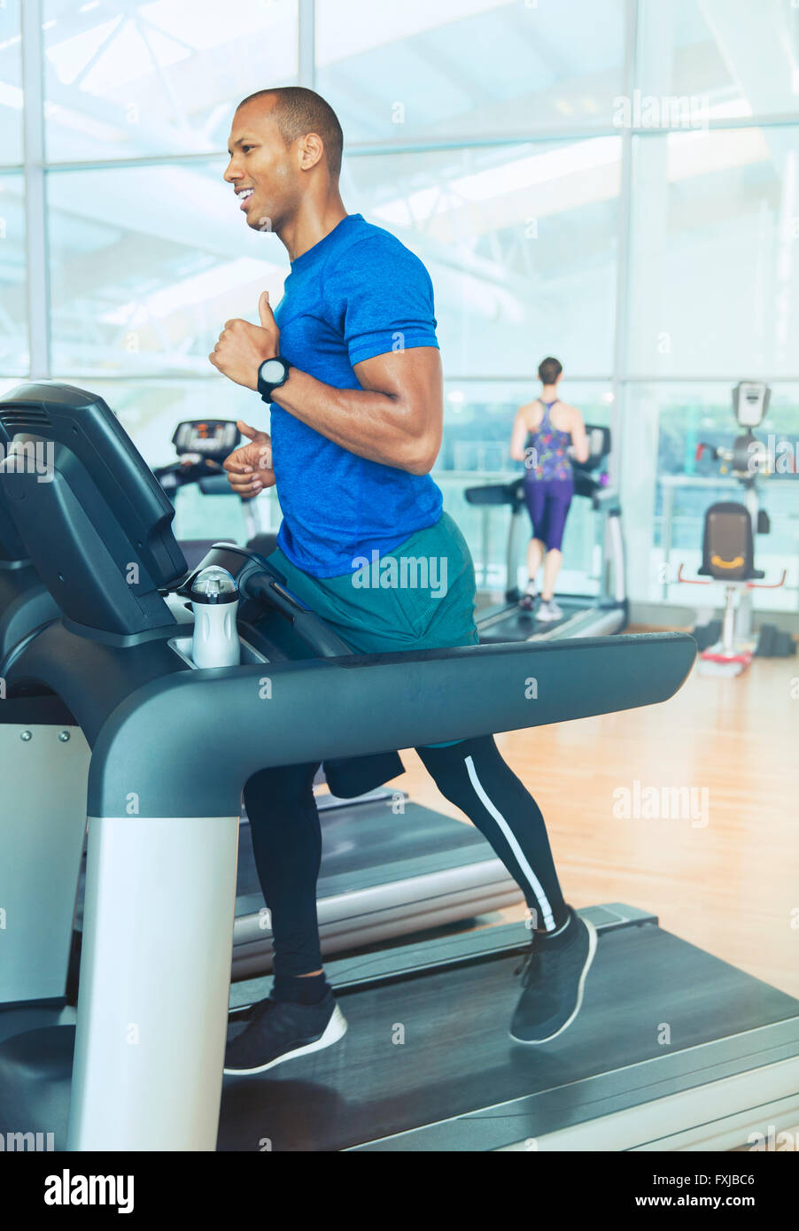 Man running on treadmill at gym Stock Photo