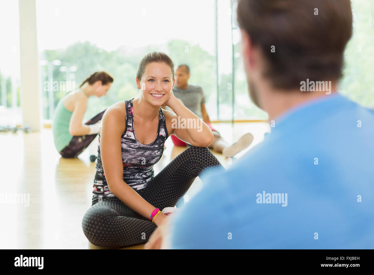 Smiling woman talking to man at gym Stock Photo