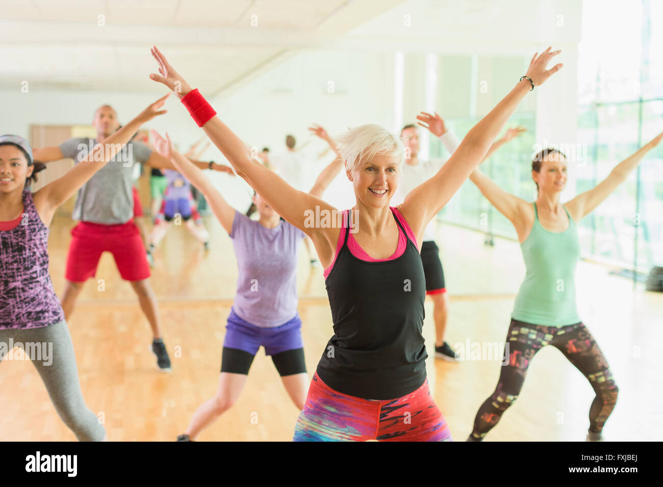 Fitness instructor leading aerobics class Stock Photo