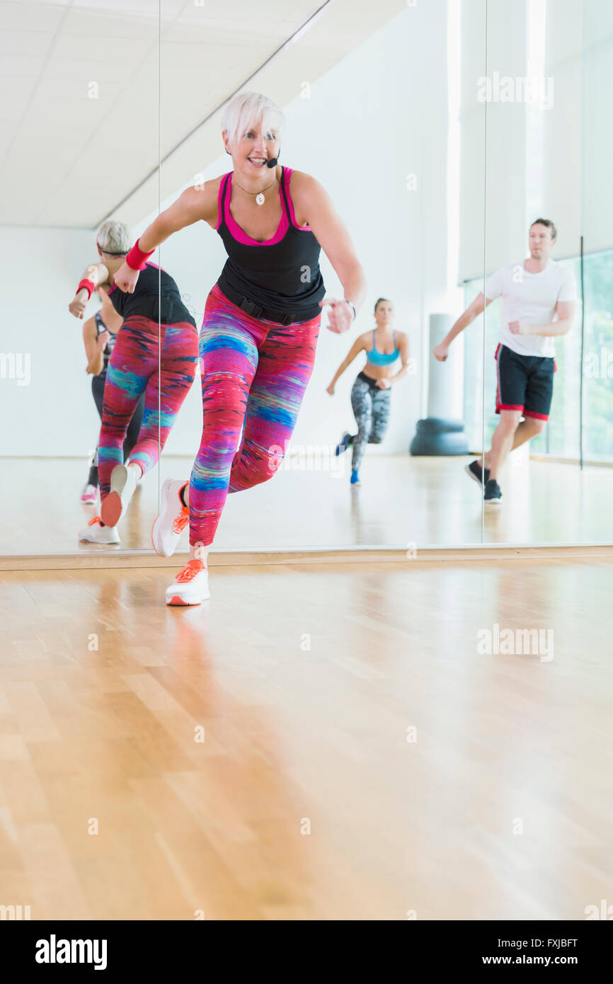 Energetic fitness instructor leading aerobics class Stock Photo