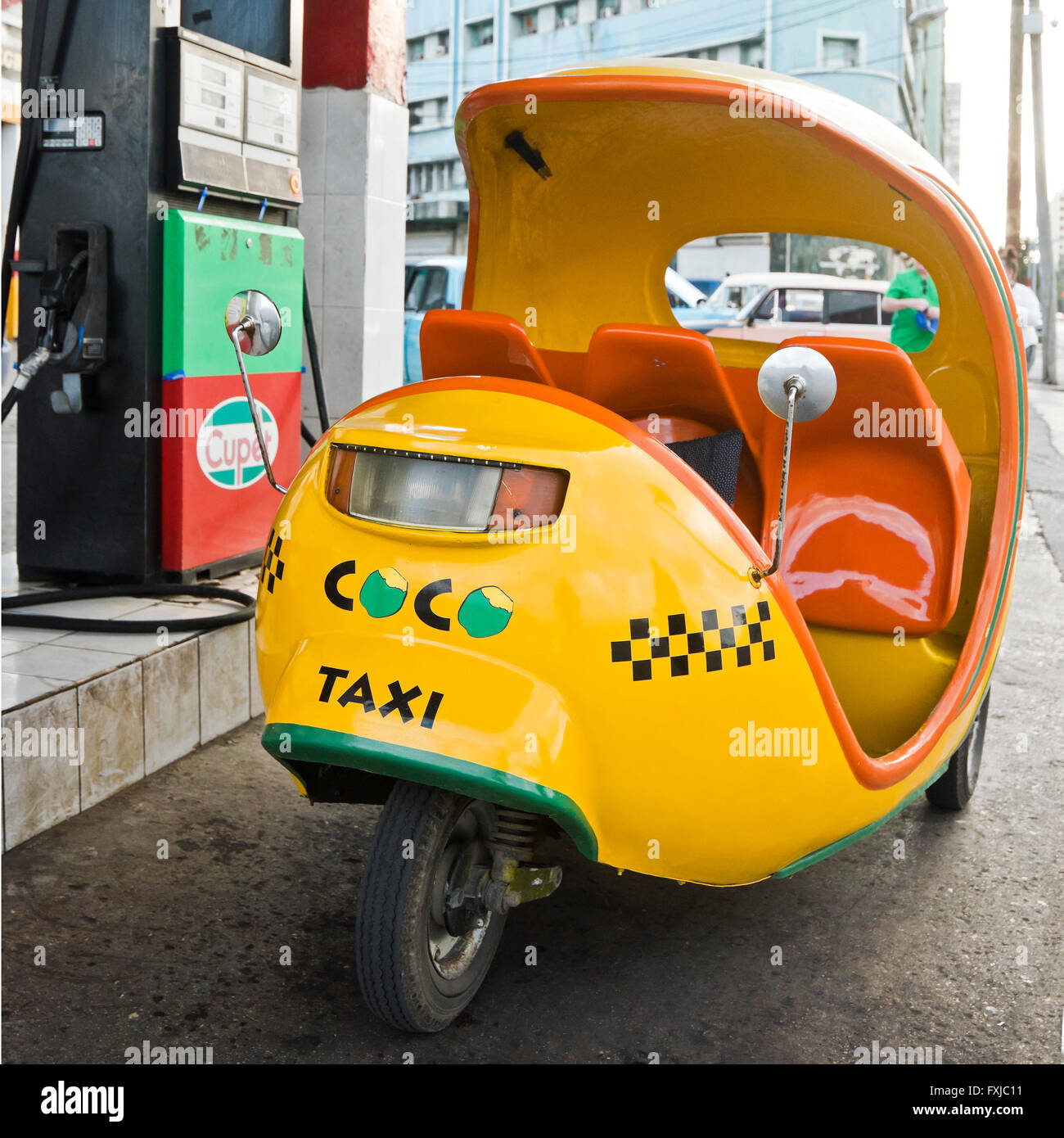 Square view of a coco taxi on a petrol station forecourt in Havana, Cuba. Stock Photo