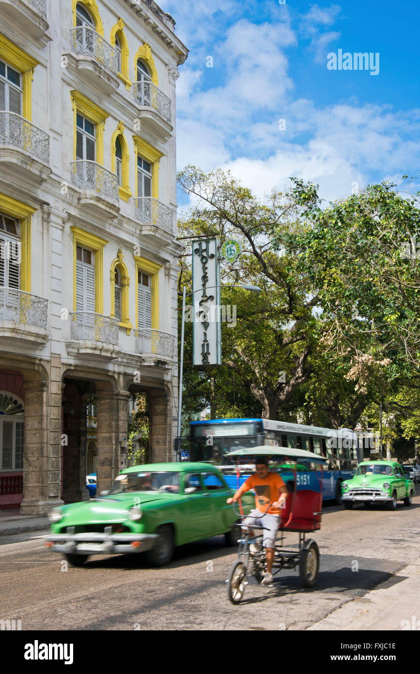 Vertical view of a vintage American car driving by Hotel Sevilla in Havana, Cuba. Stock Photo
